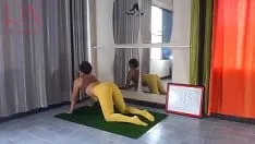 Play Regina noir. yoga in yellow tights doing yoga in the gym. 1